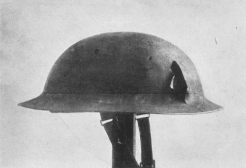 HELMET WORN BY FLOYD GIBBONS WHEN WOUNDED, SHOWING
DAMAGE CAUSED BY SHRAPNEL