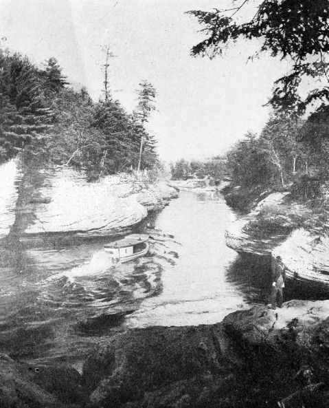 THE NARROWS, DELLS OF THE WISCONSIN

One hundred feet deep. The river seems almost to be running on its edge
hemmed in by ponderous rocks. Courtesy Wisconsin Geological Survey