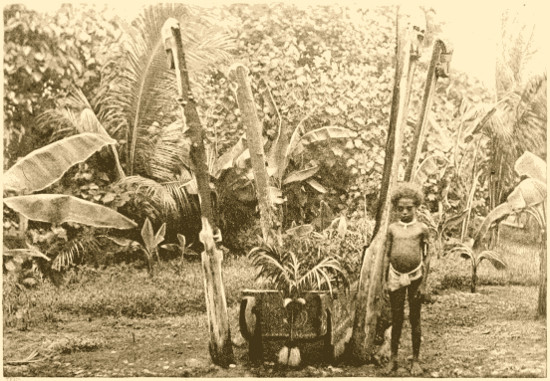 Child standing next to coffin