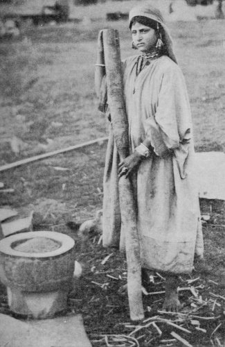 WOMAN POUNDING GRAIN