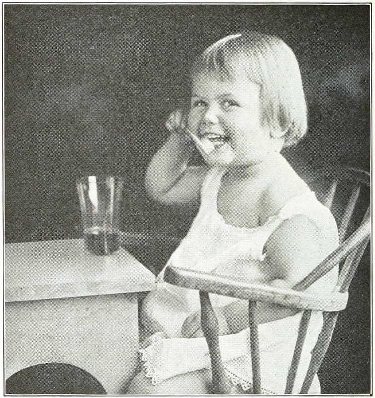 A child brushing their own teeth